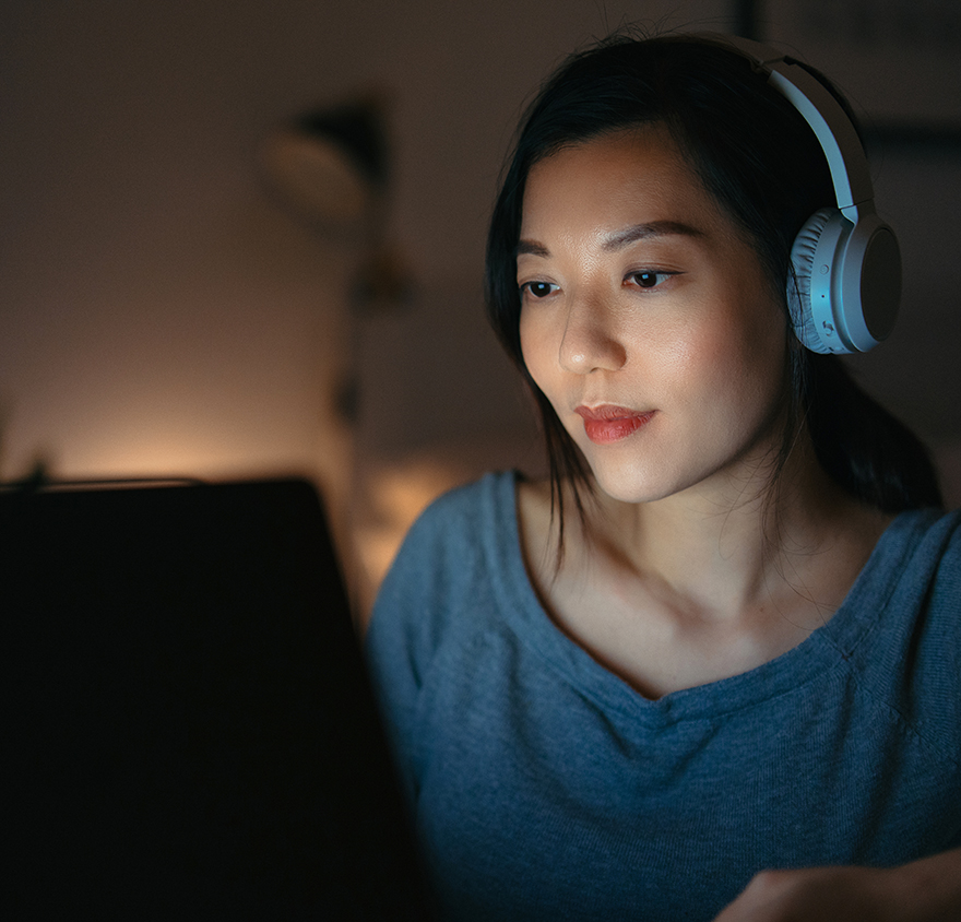 Woman at a laptop with headphones on