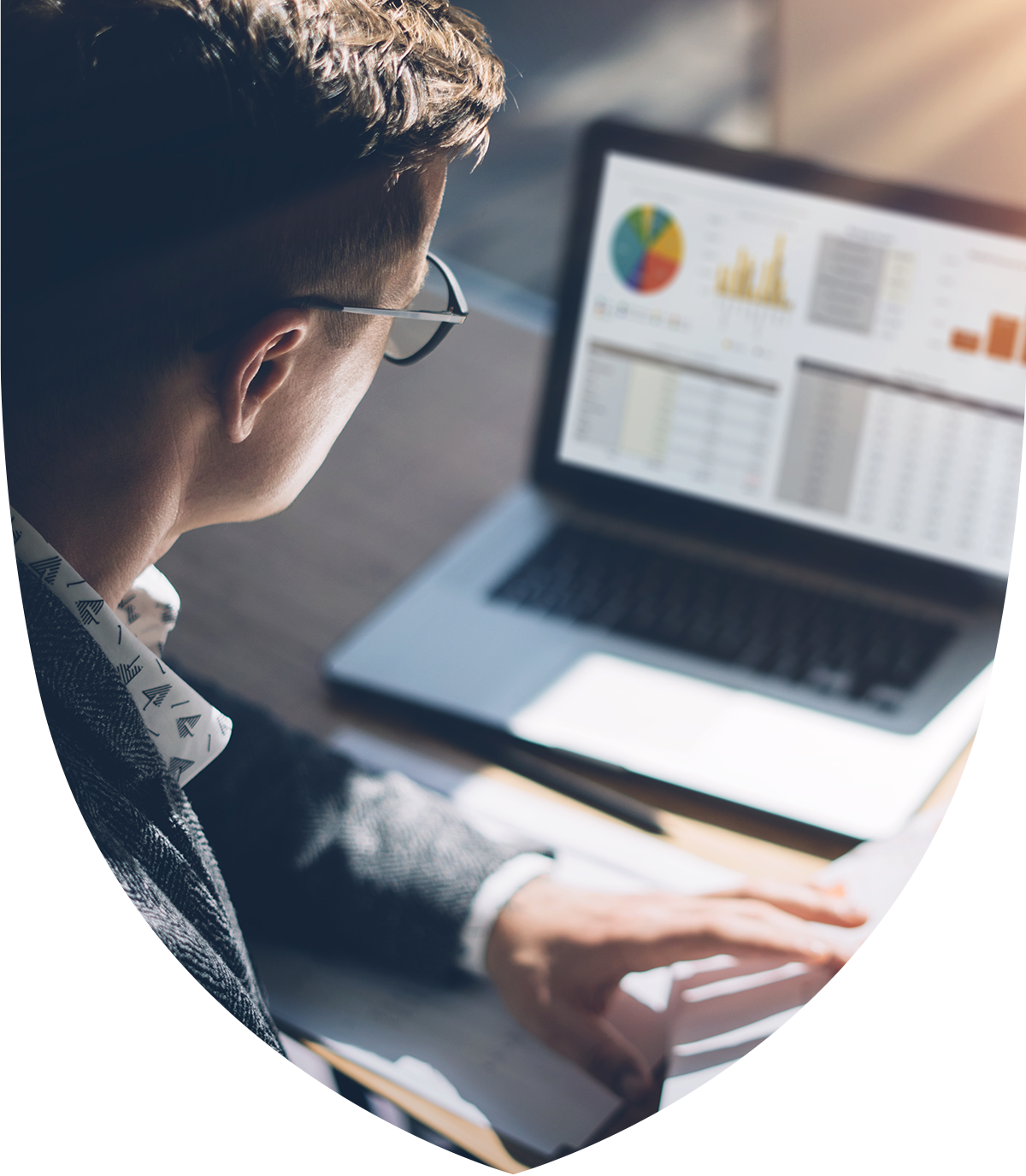 A man looking at graphs on a laptop