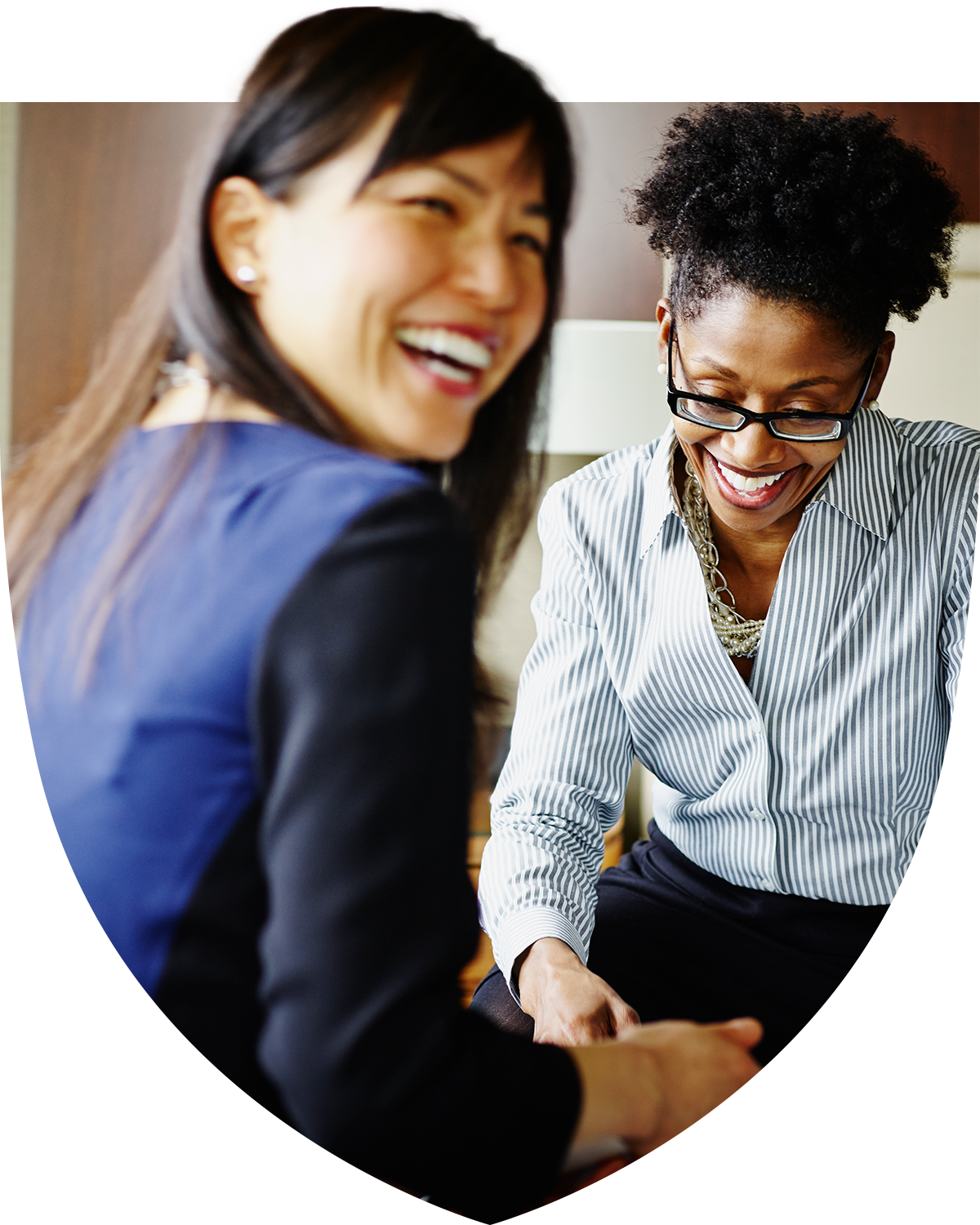 Two professional women laughing together