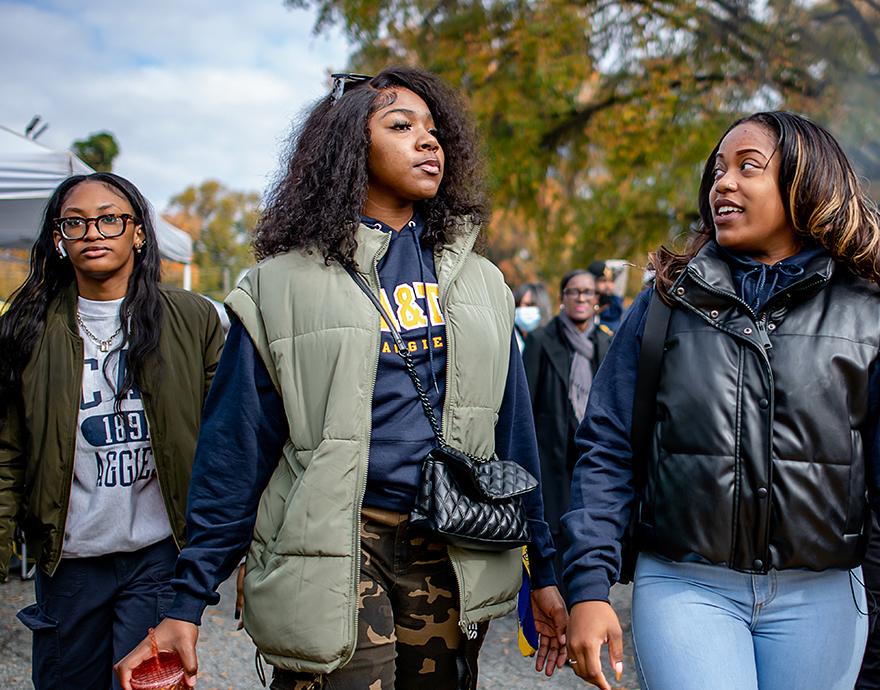Diverse students walking through campus