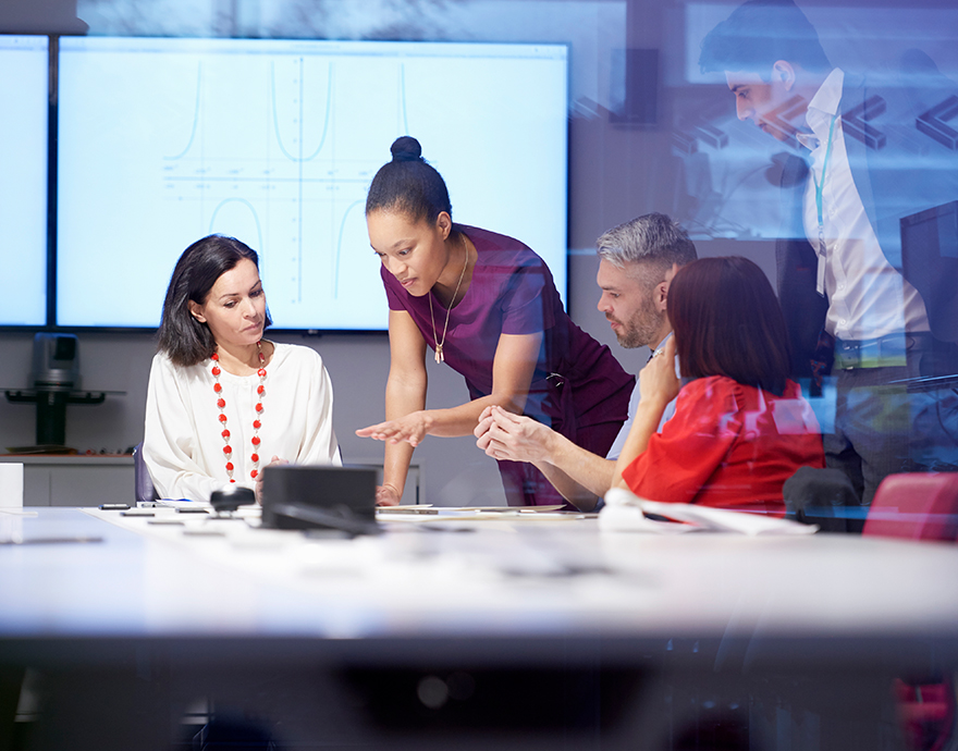Four people having a meeting at a table