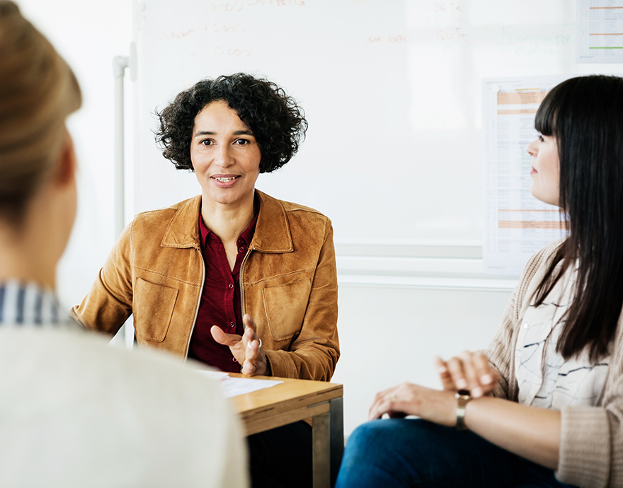 Three women talking in a meeting 