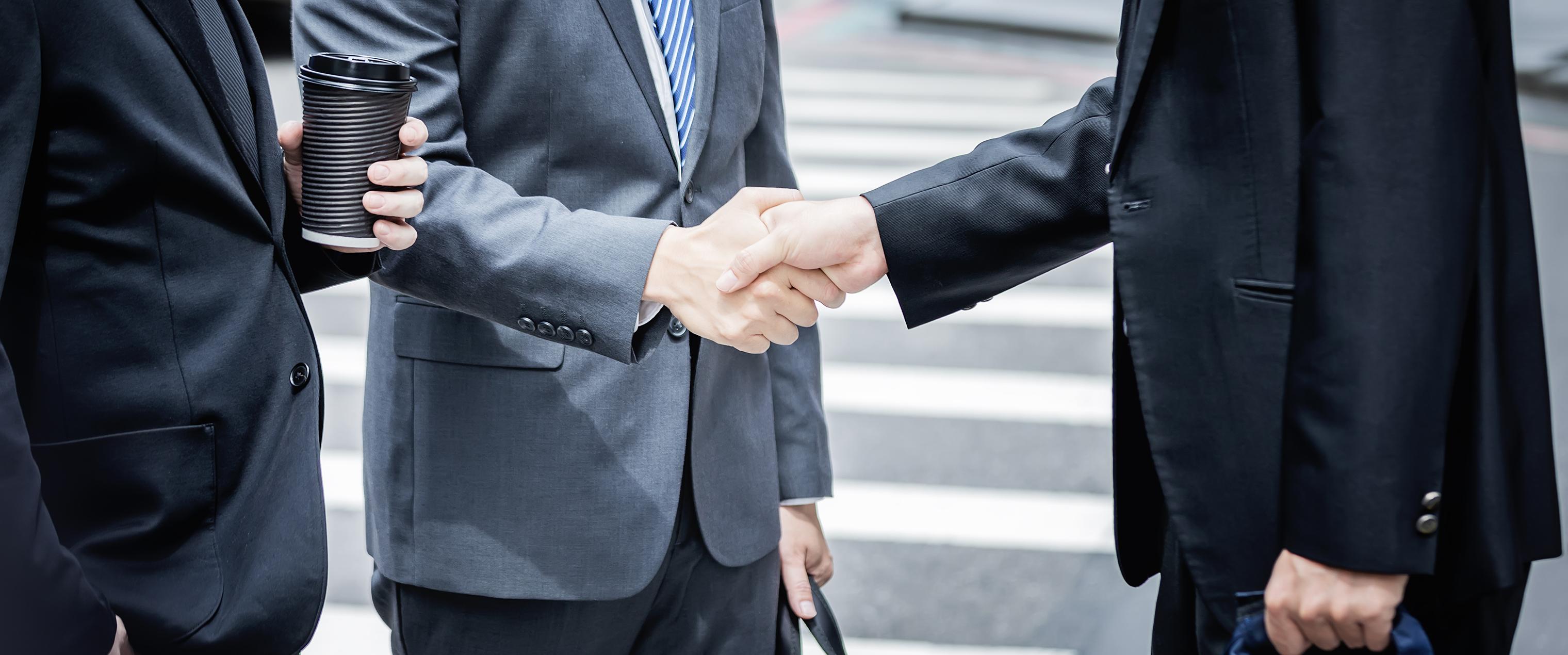 Financial professionals shaking hands
