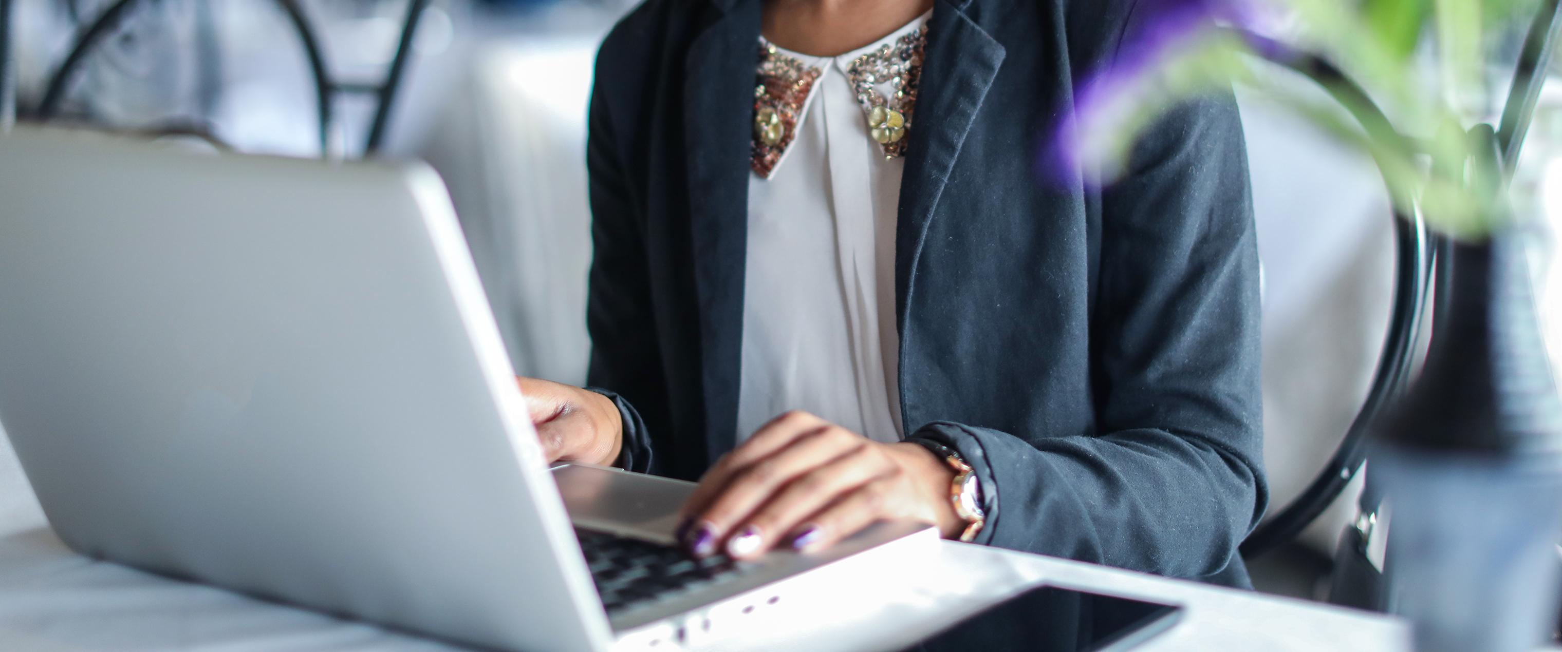 Close up of a woman working on a laptop