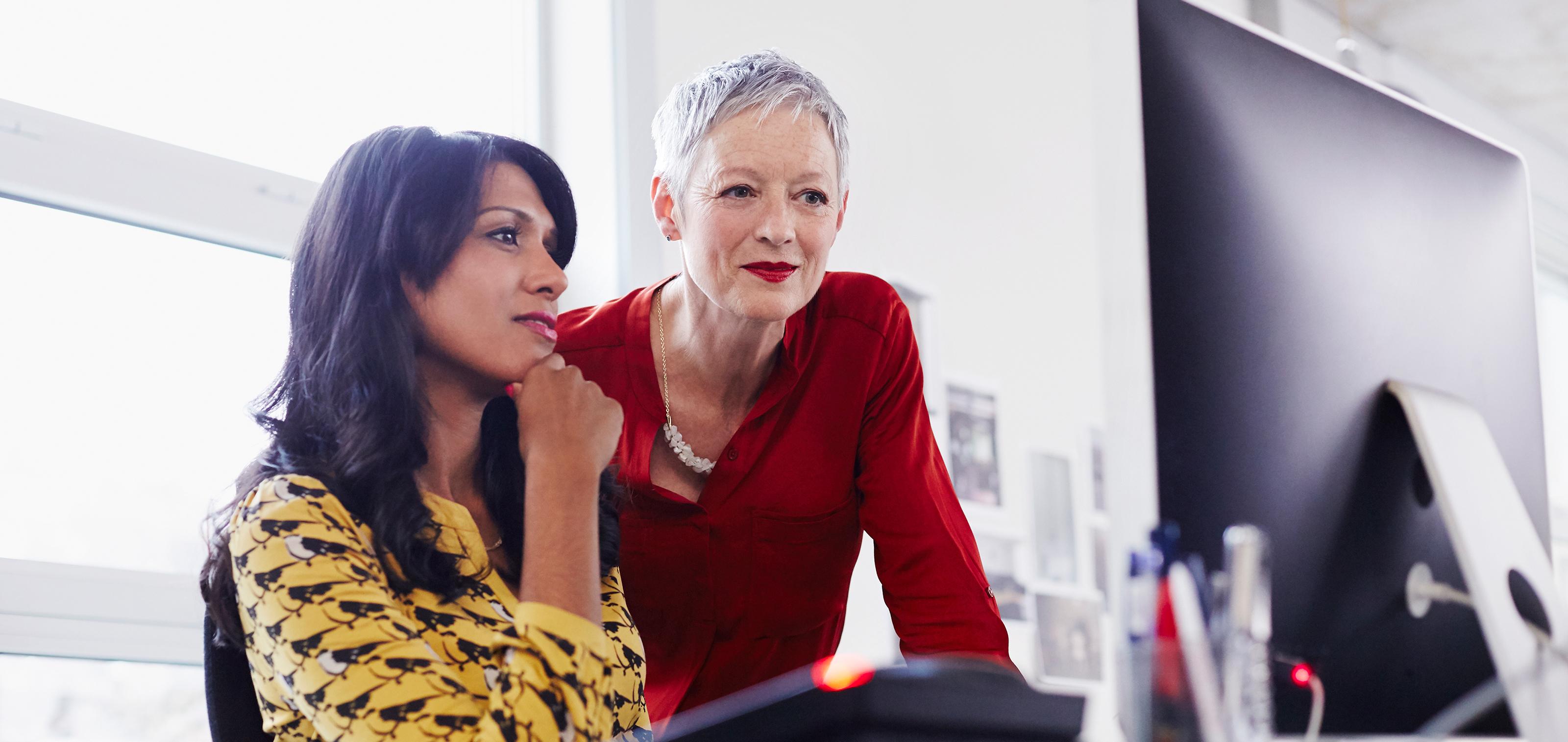 Two women looking at a computer