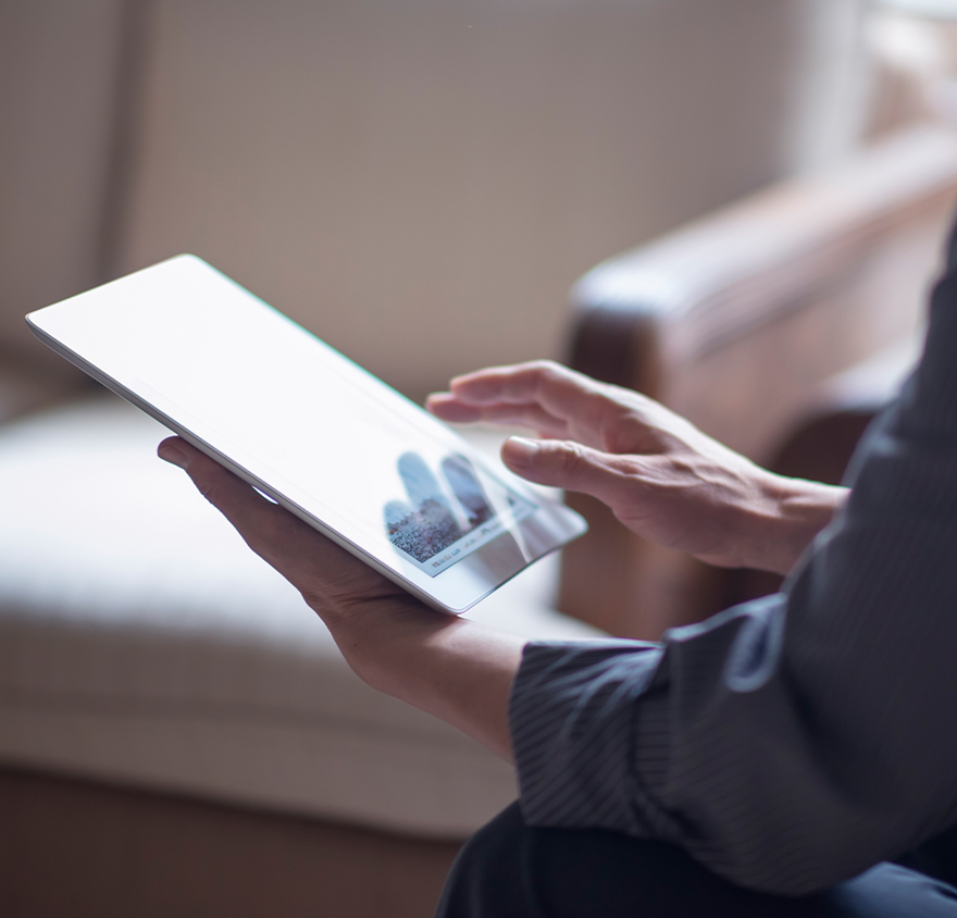Close up of hands working on a tablet
