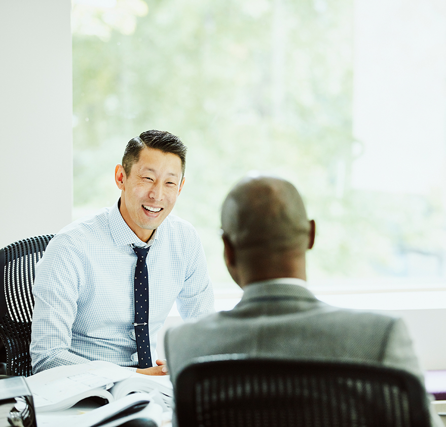 Two men talking at a table