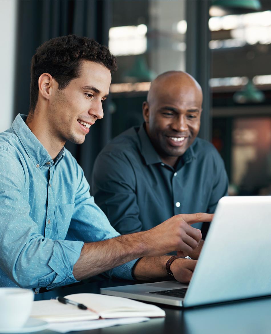 Two men looking at and pointing to a computer