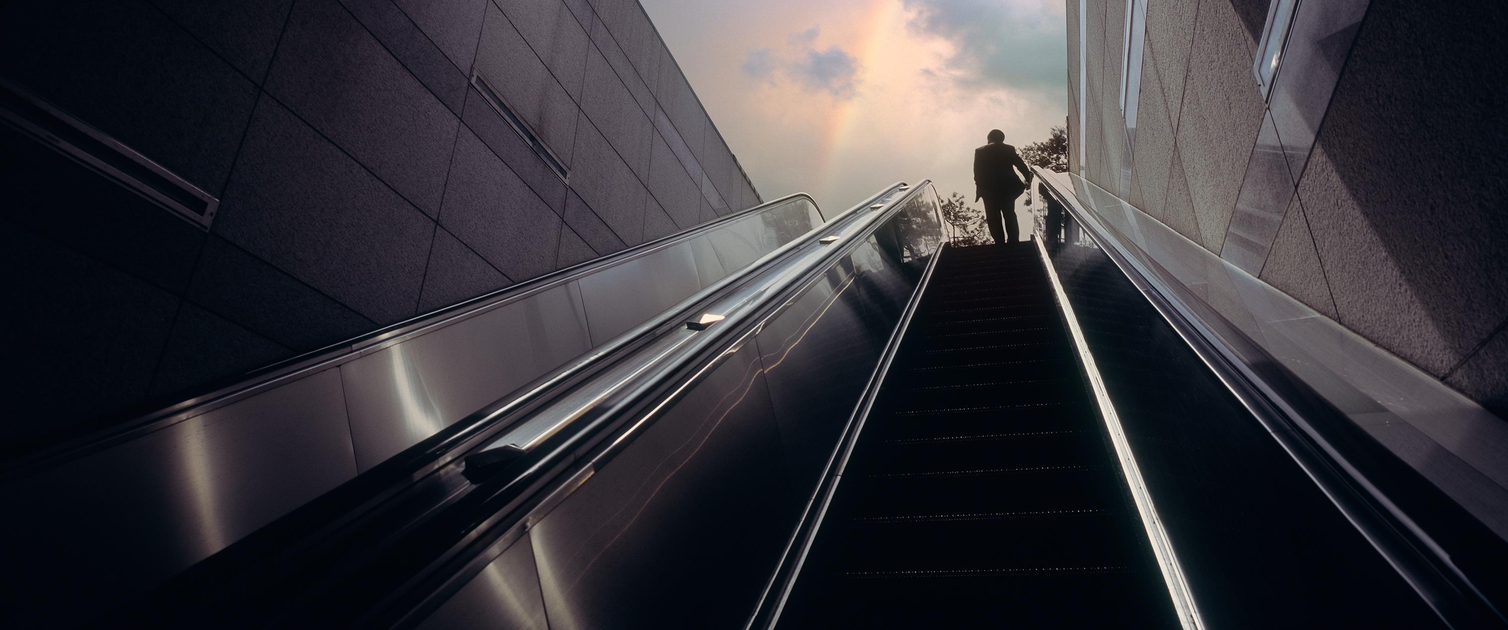 Man riding an escalator