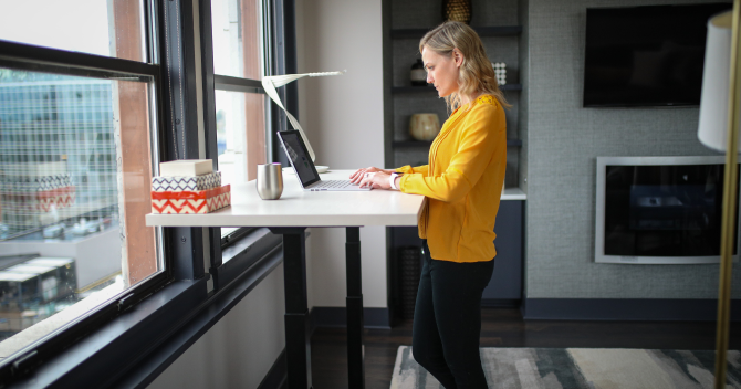 woman standing at computer desk