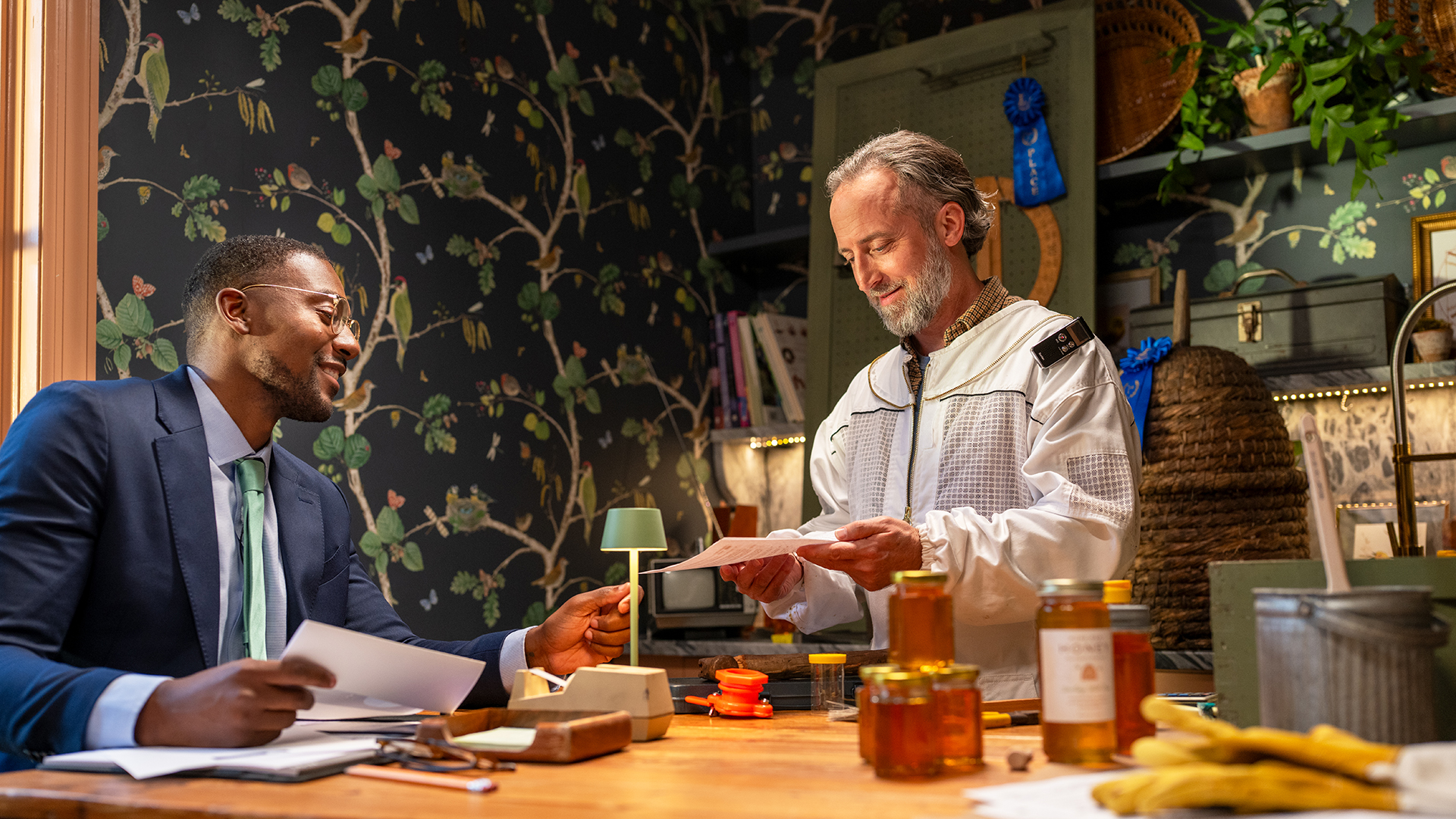 Beekeeper sitting at the table with his financial advisor