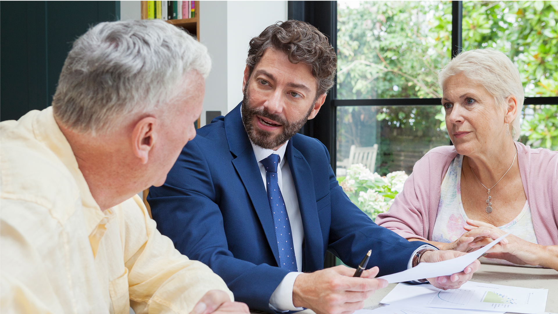 Financial advisor meeting with two elderly clients