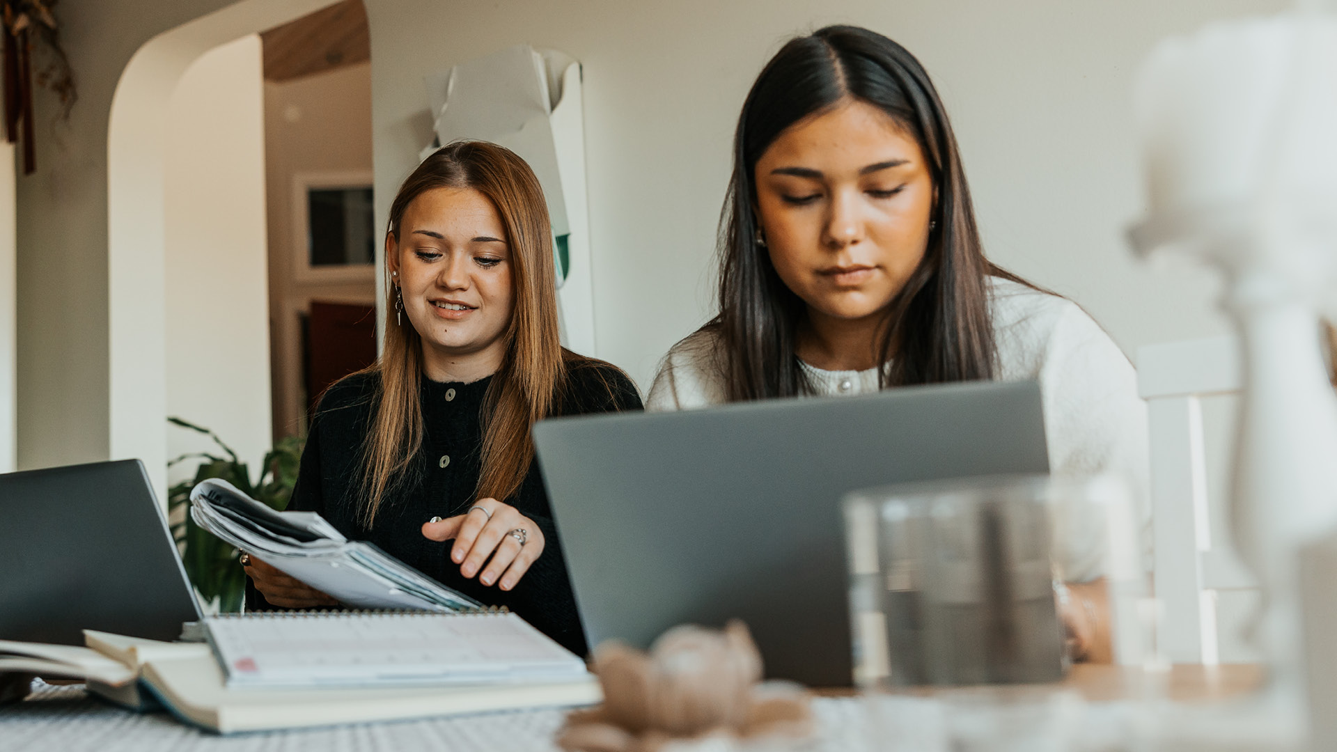 Two Gen Z females studying at their desk