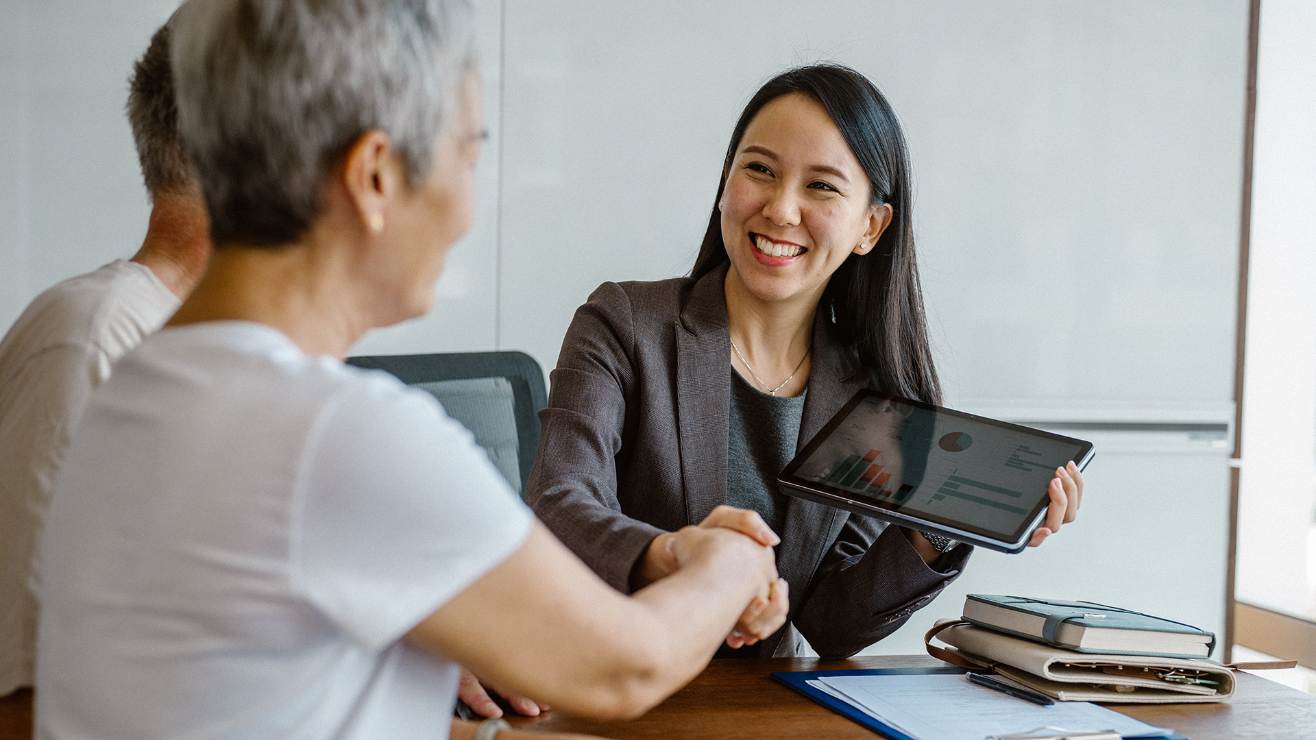 Female retirement advisor meeting with her clients