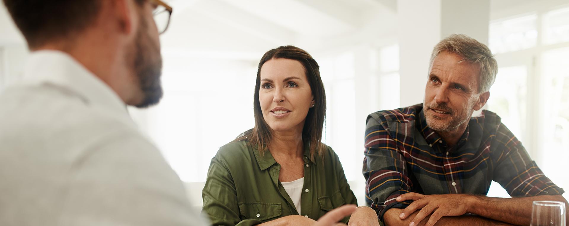 A couple speaking with an advisor about retirement options