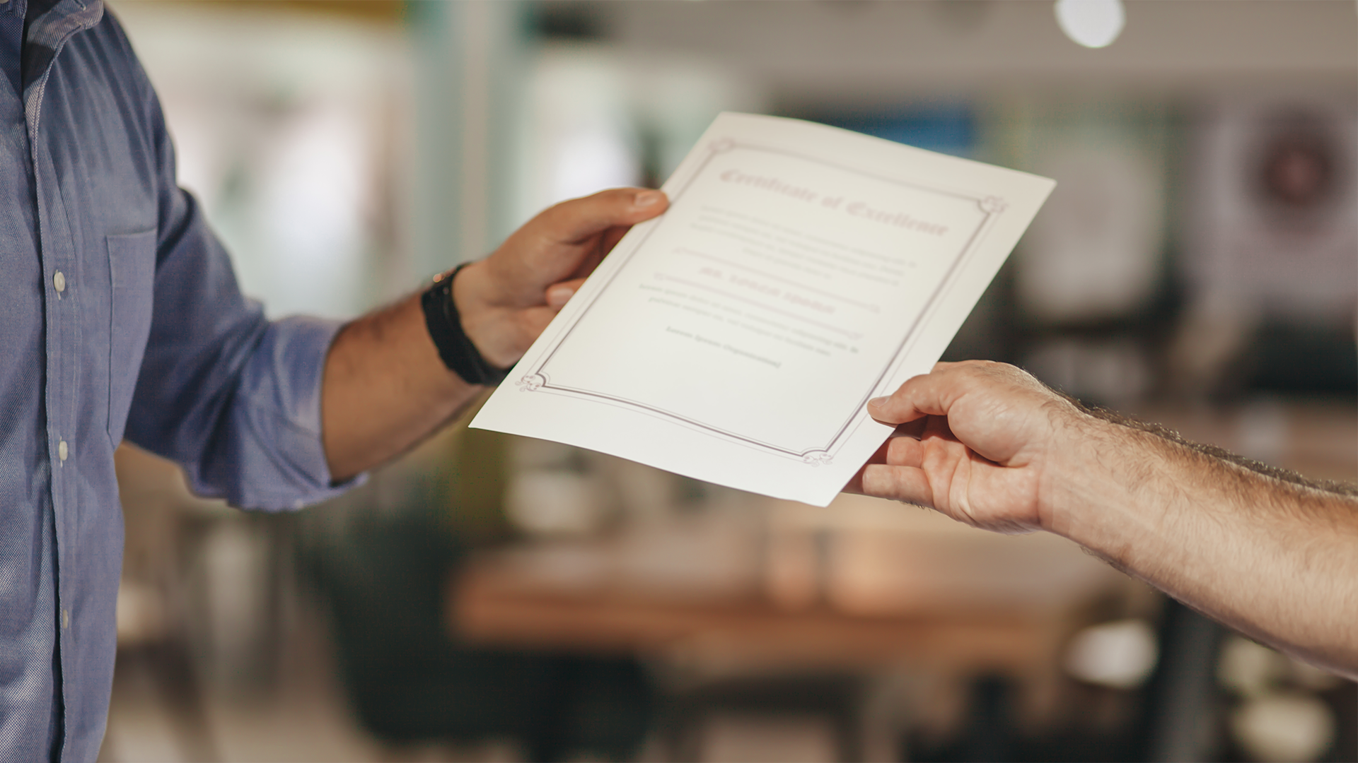 Man being handed his proof of certification