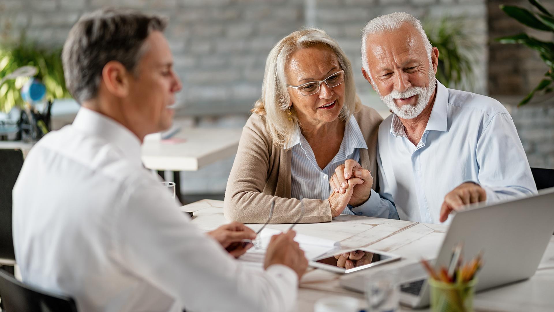 Retirement professional helping an elderly couple plan