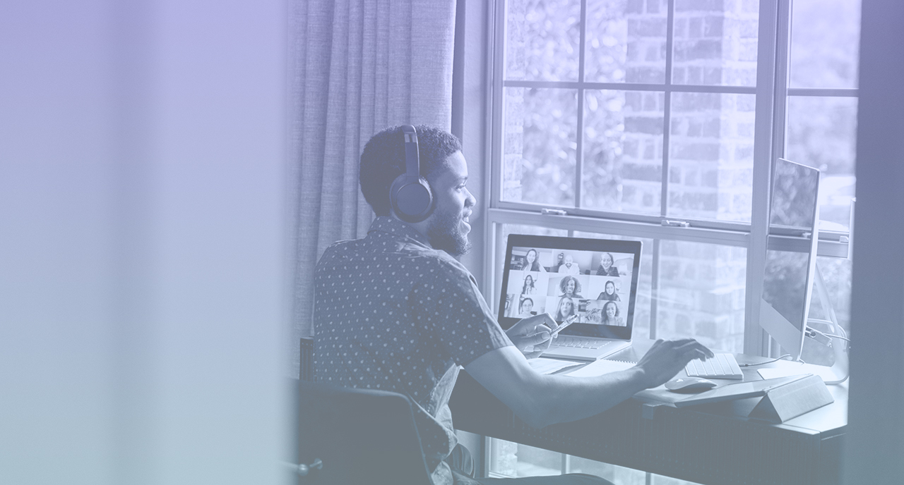 Young professional on a virtual meeting at his desk