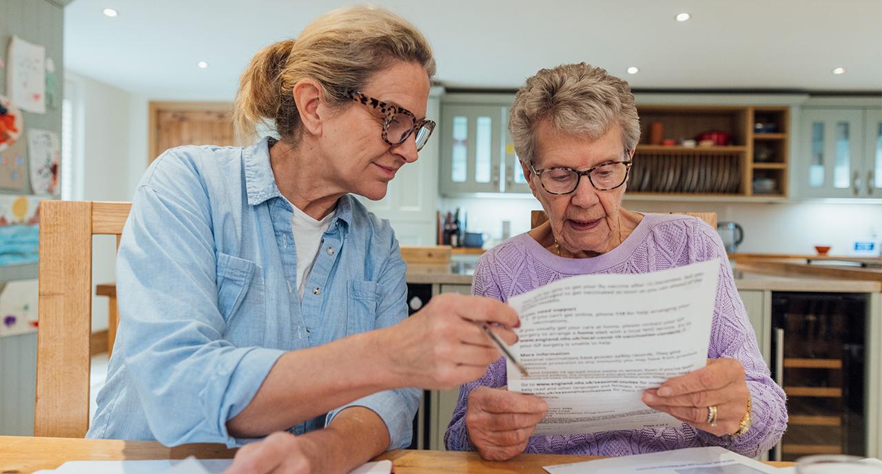 Daughter helping her mother with retirement paperwork