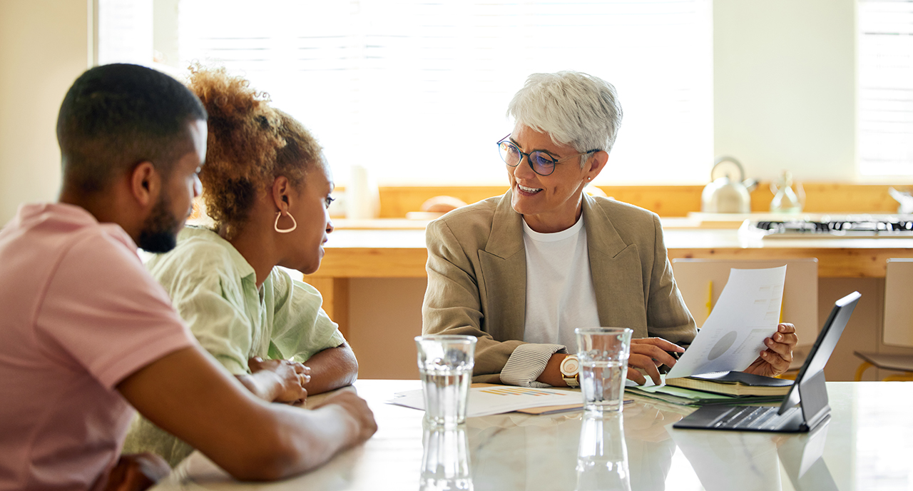 Senior financial advisor helping a young married couple