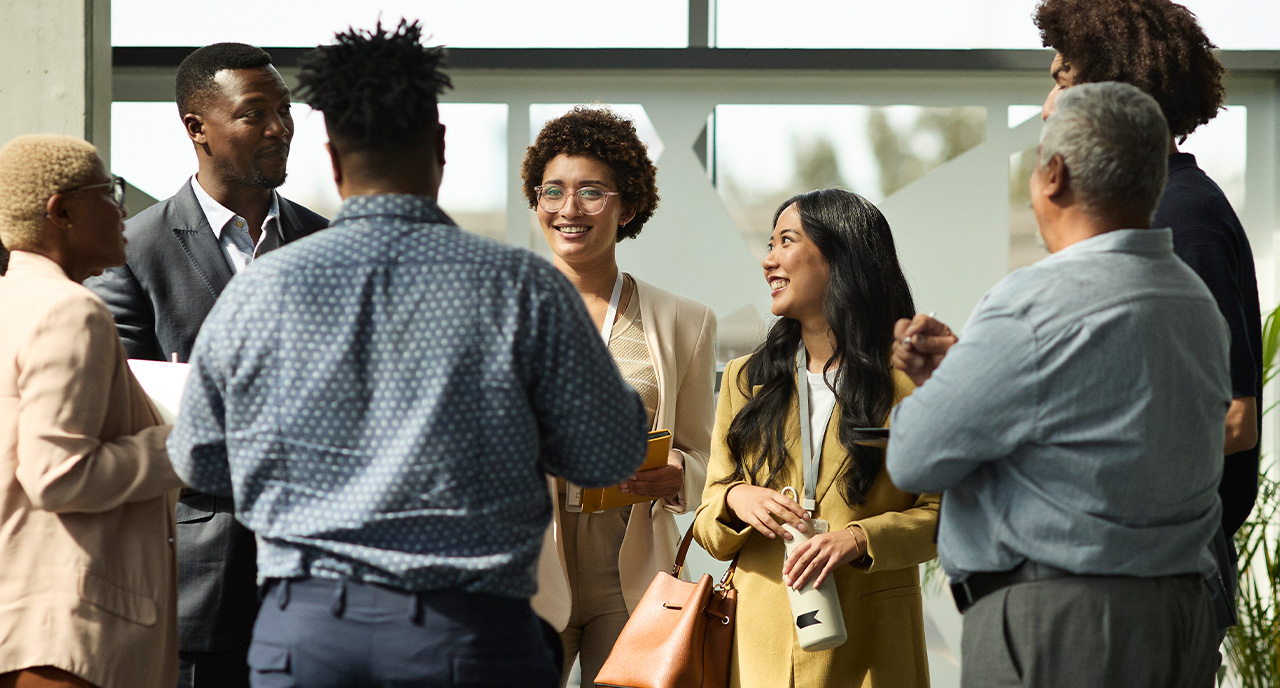 Diverse group of young professional standing in a circle talking