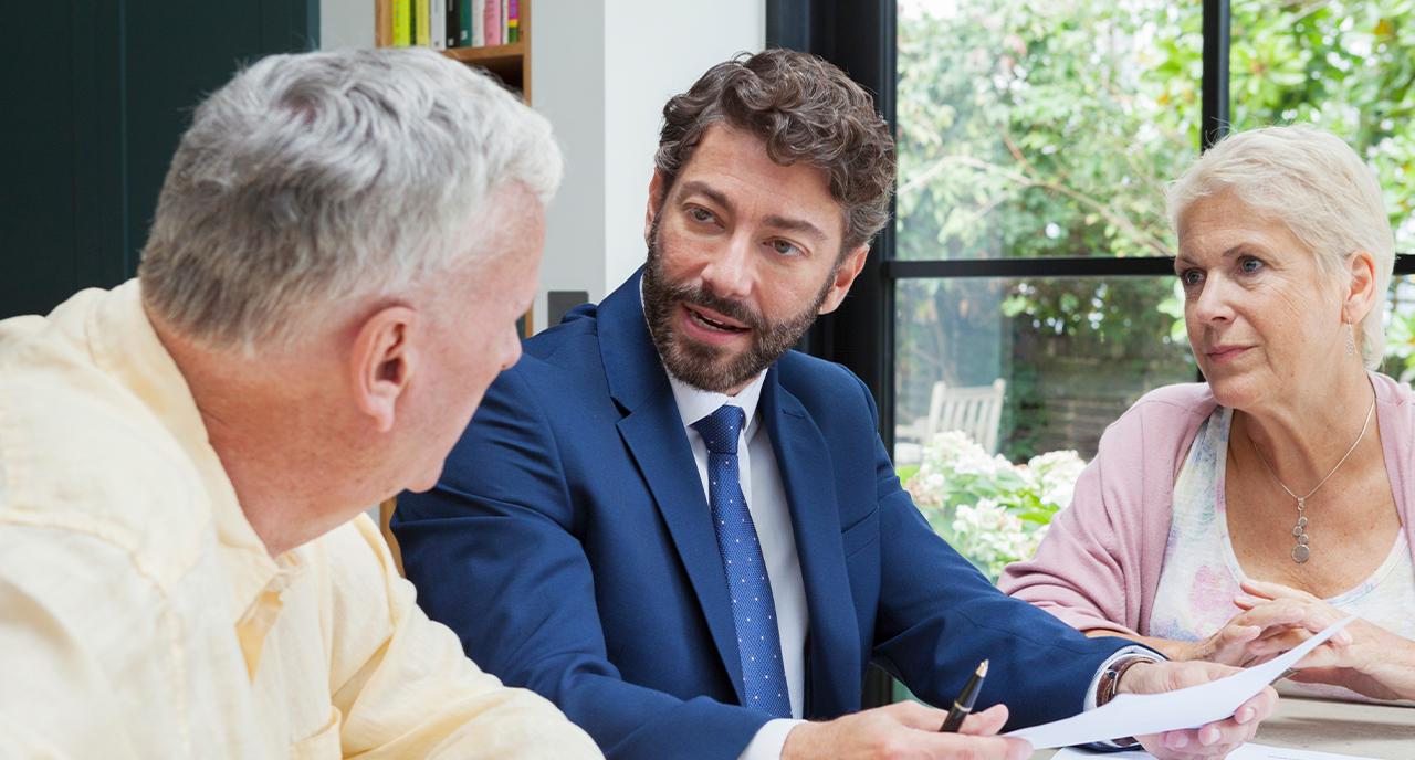 Financial advisor meeting with two elderly clients