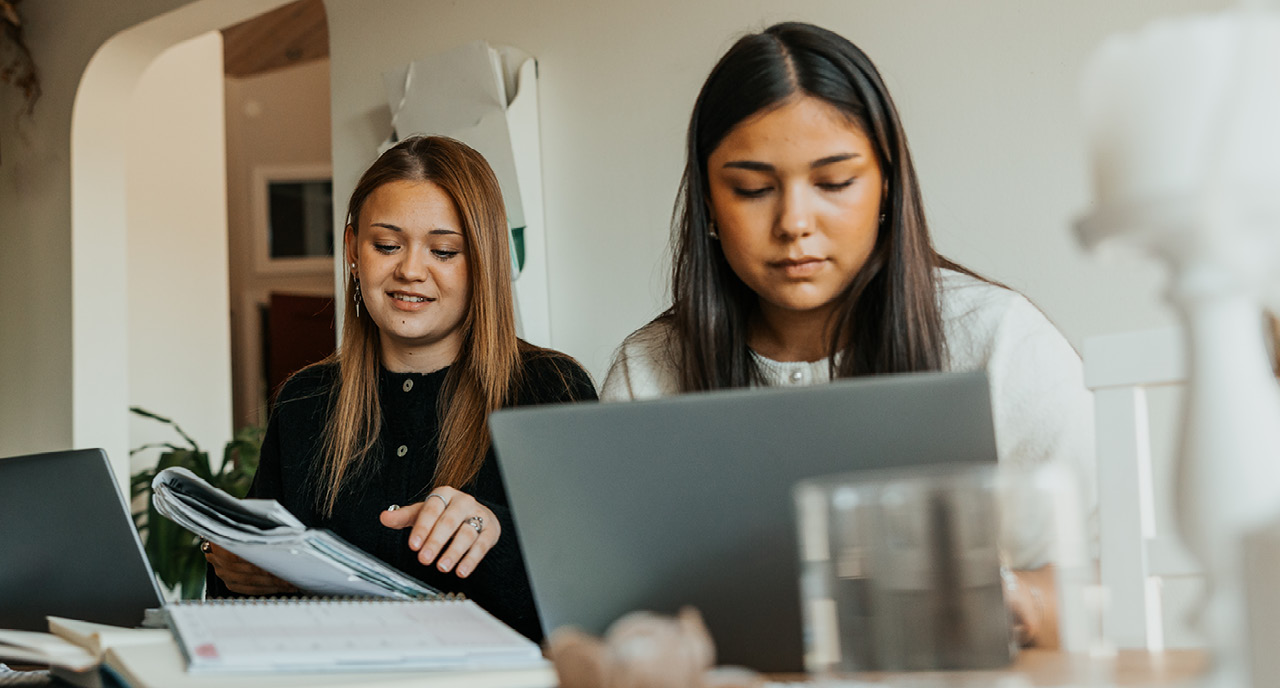 Two Gen Z females studying at their desk