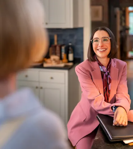 Female advisor in purple suit smiling