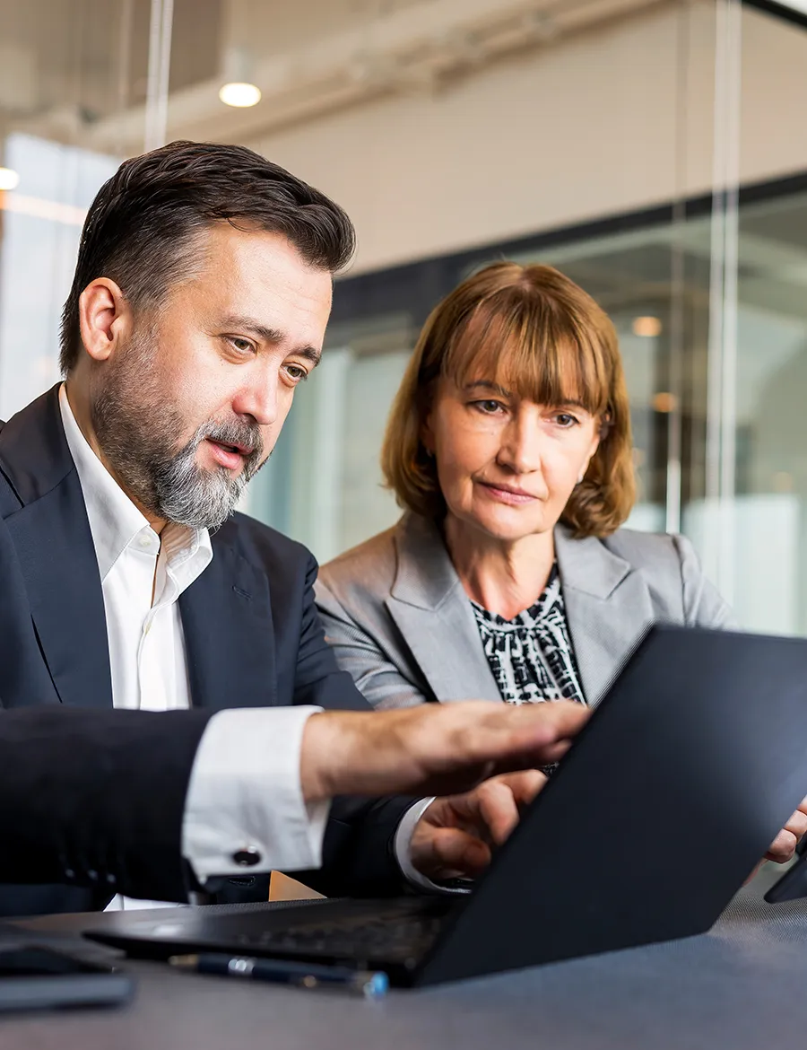 Two work colleagues looking at the laptop together