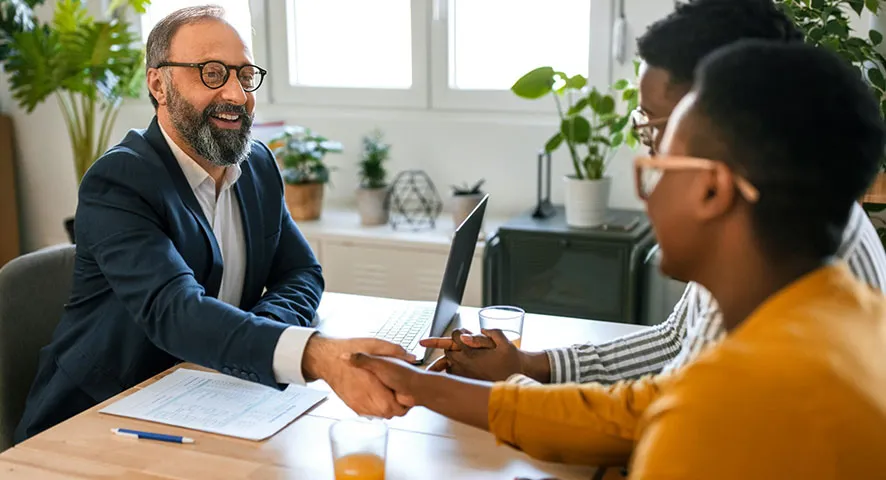 Seniored male advisor meeting with a middle aged married couple