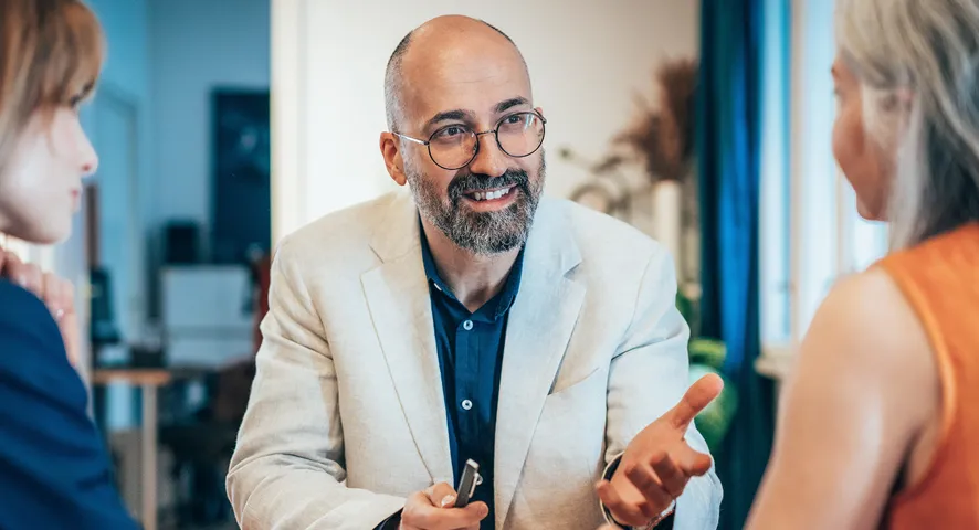 Male advisor meeting with two women