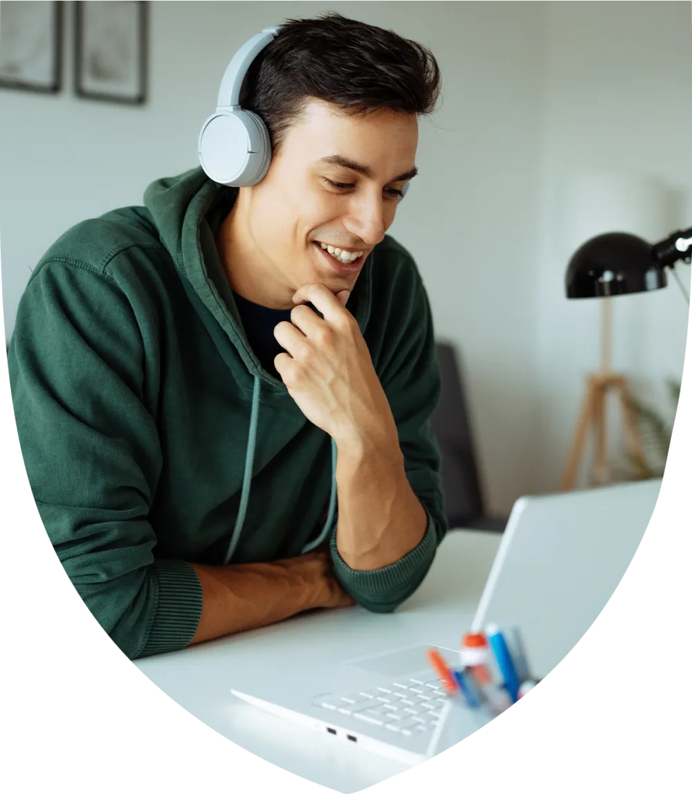 Man in his 30's taking a meeting on his laptop