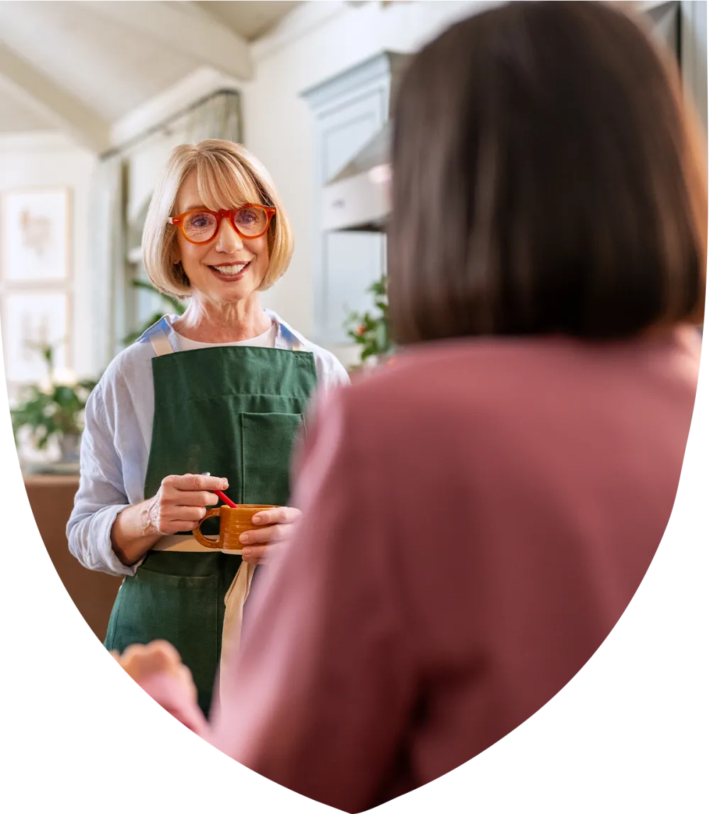 Elderly woman in apron speaking with her retirement advisor