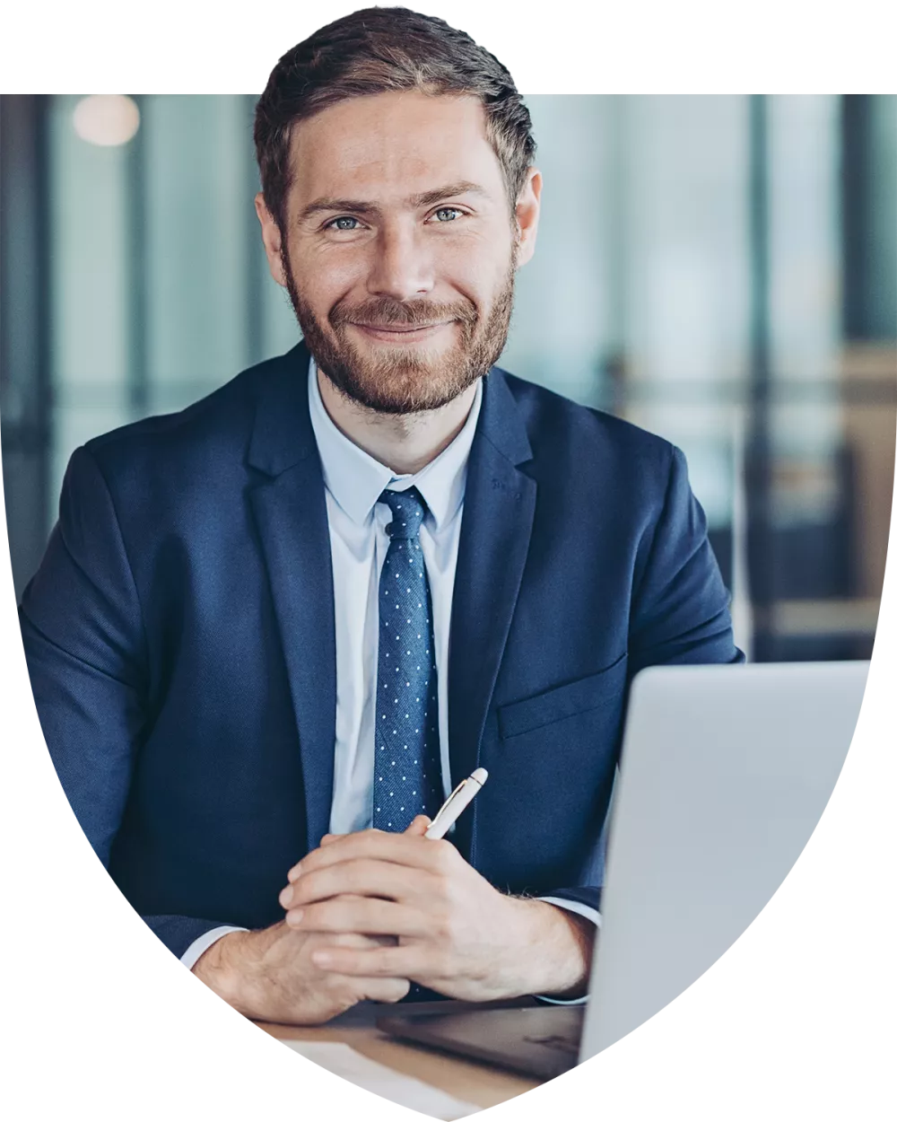 Young financial professional smiling at his desk