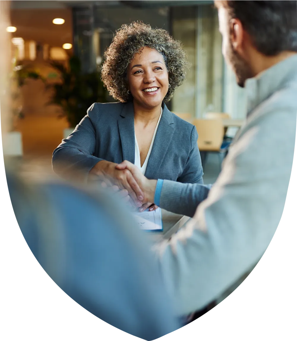 Middle aged woman smiling and shaking hands