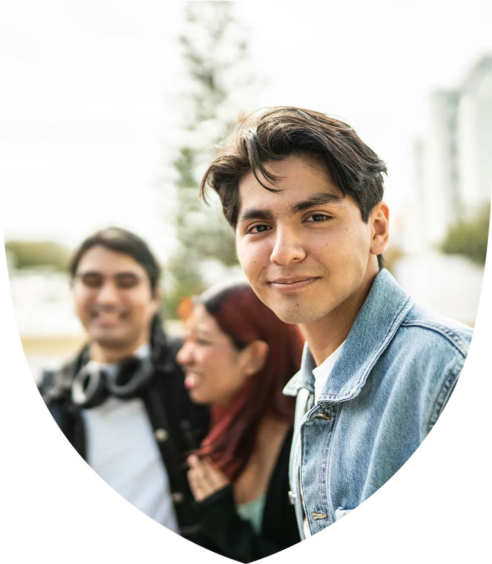 Young latino student smiling with friends