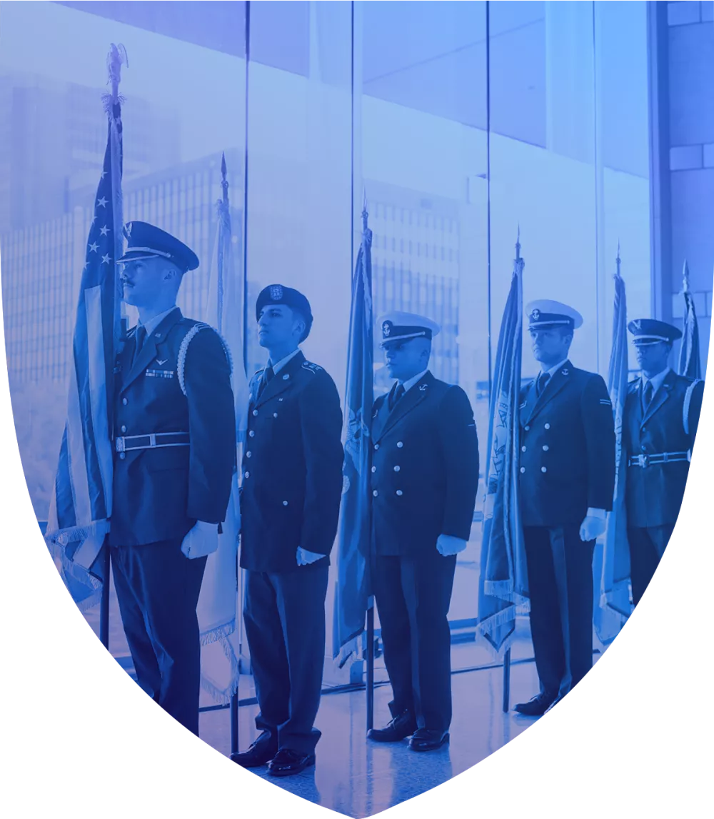 Line of servicemen in formation holding flags