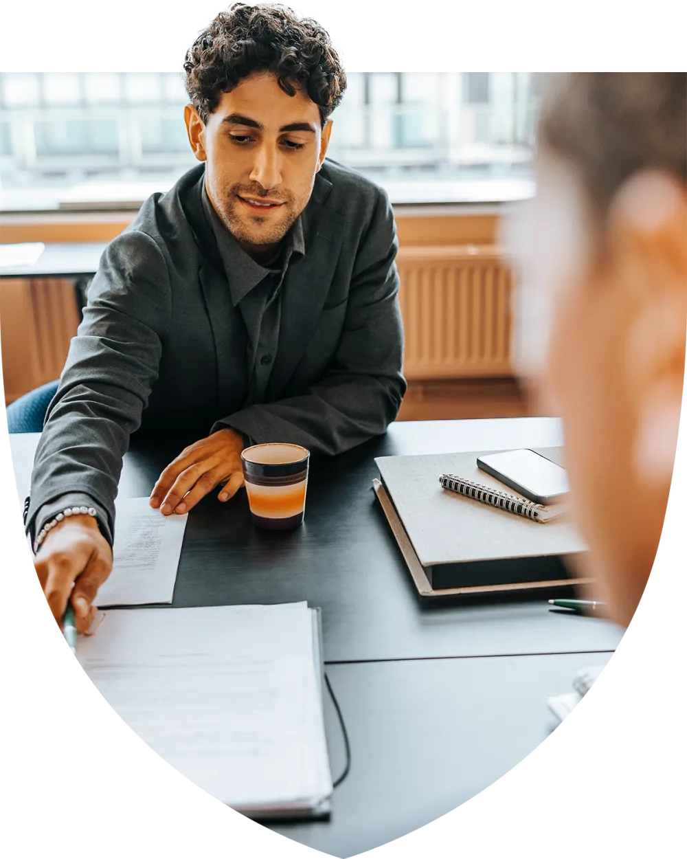 Man in his mid thirties speaking with a female advisor