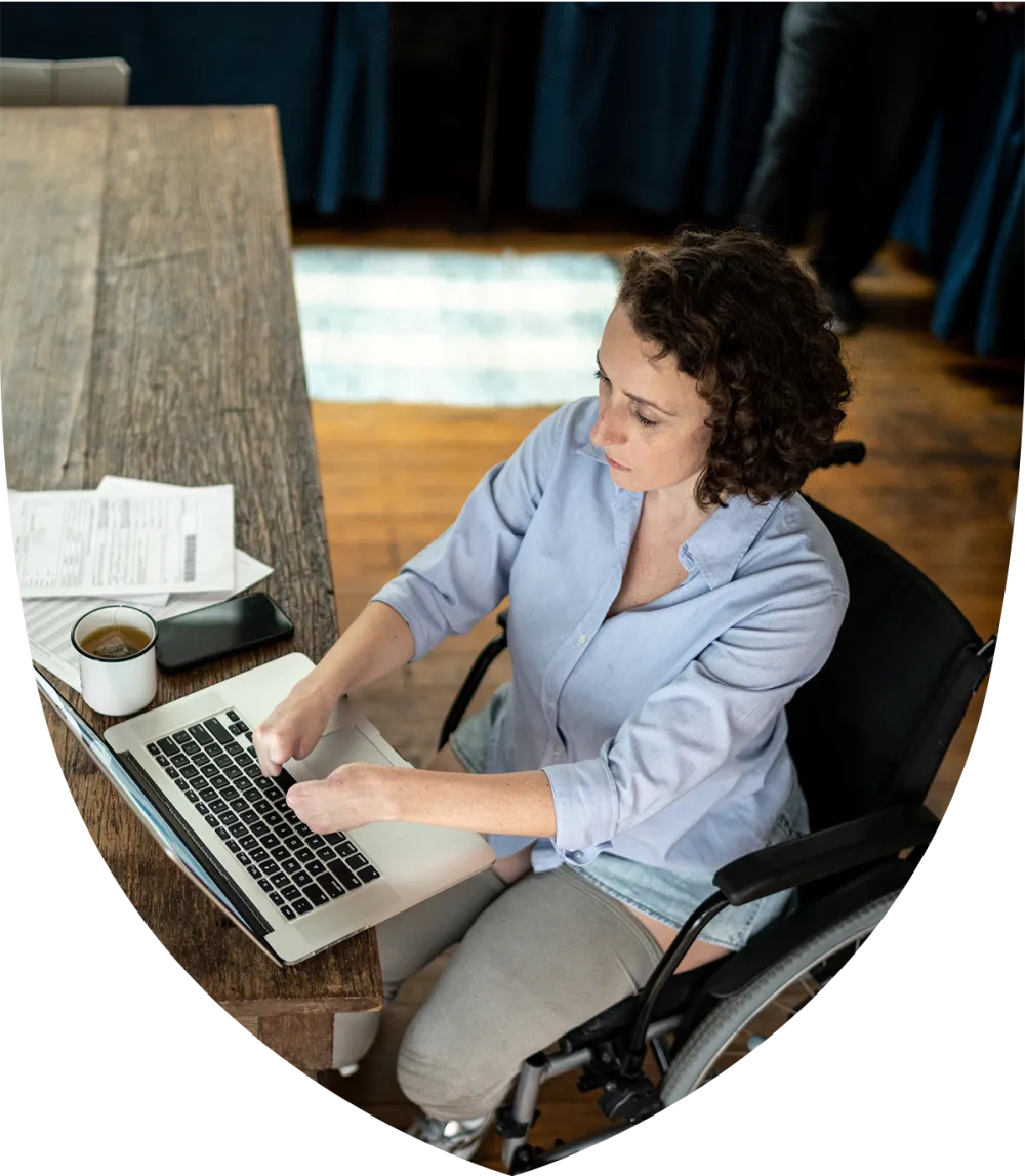 Middle aged woman with special needs sitting at her desk working
