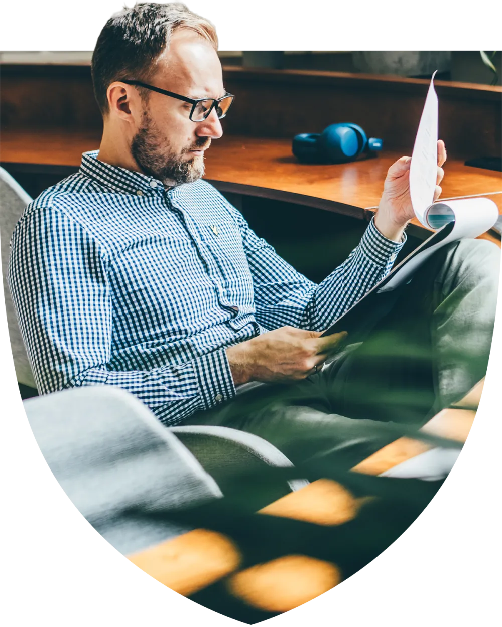 Middle aged man sitting at his desk looking through paperwork