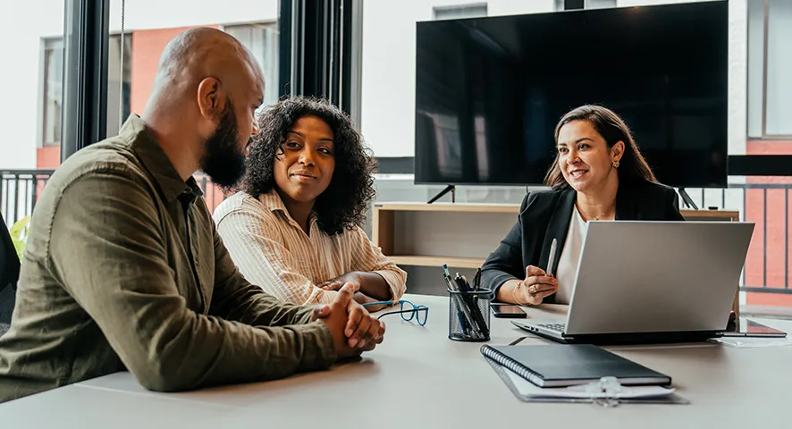 Female advisor meeting with married couple about their retirement