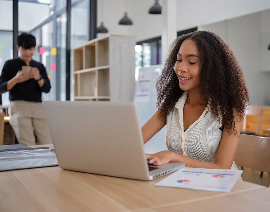 Student working on her laptop in the library