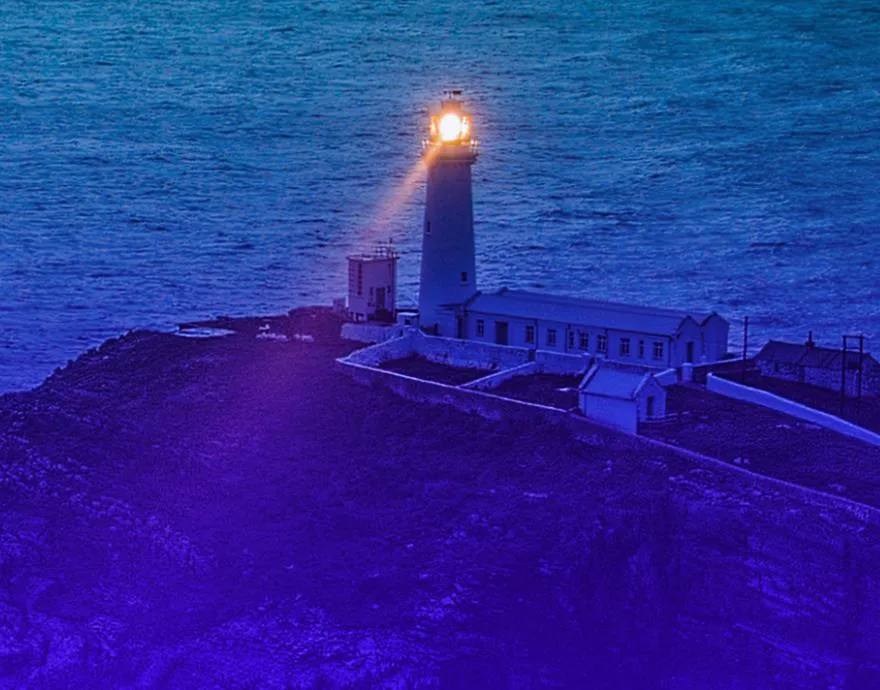 Lighthouse shining a light in the dark