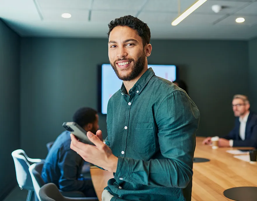 Male in his mid 30's smiling in a conference room