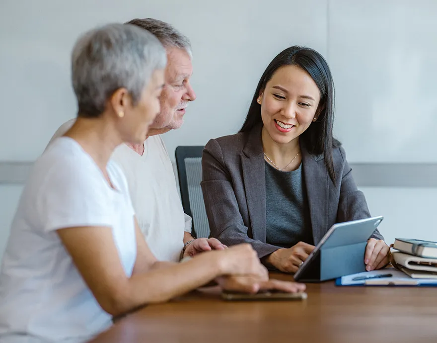 Female financial advisor working with elderly couple