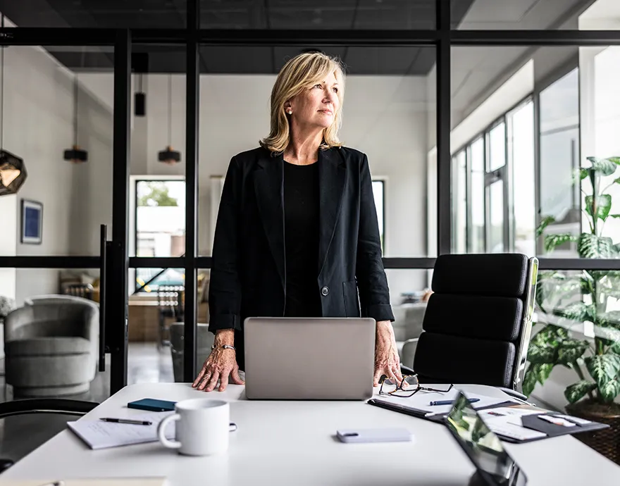 Woman standing confidently in the board room