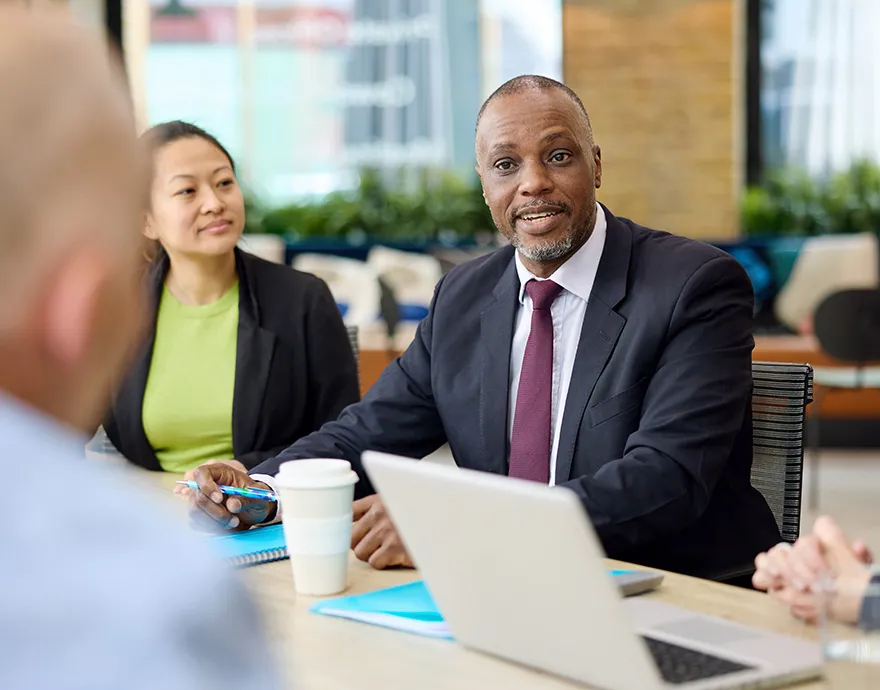 Middle aged man smiling at the conference table
