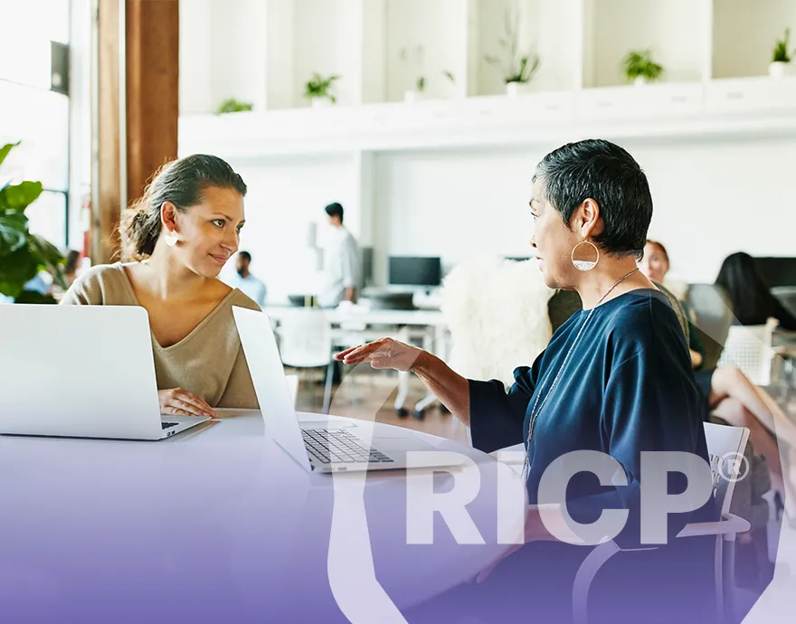 Two women speaking together at the office