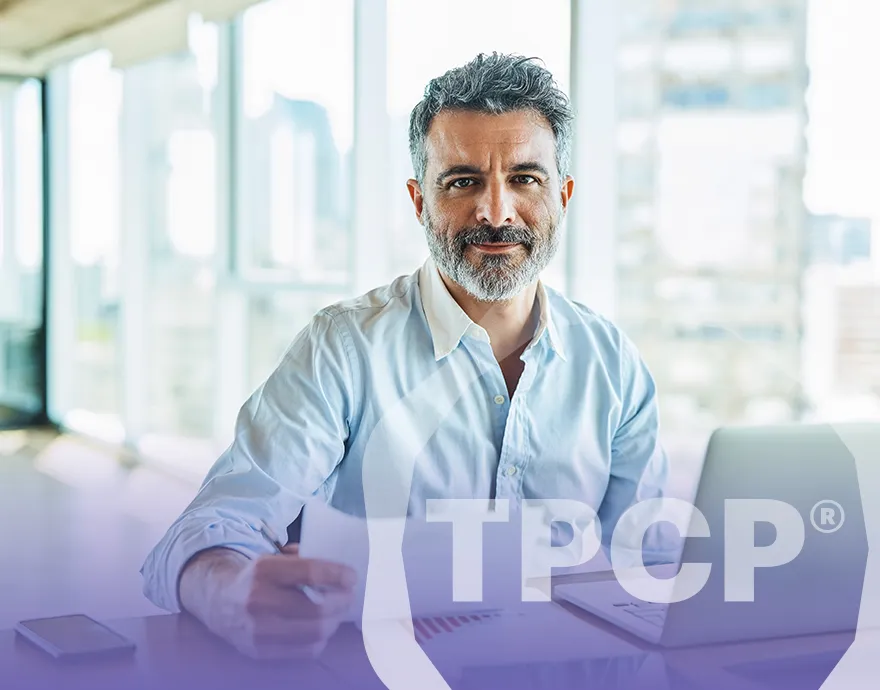 Middle aged man smiling while at his work desk