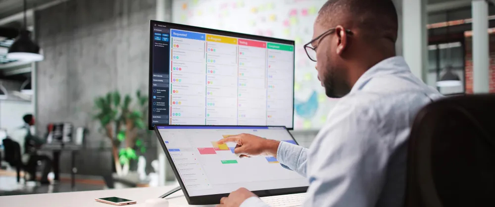 Male advisor sitting at his computer reading charts
